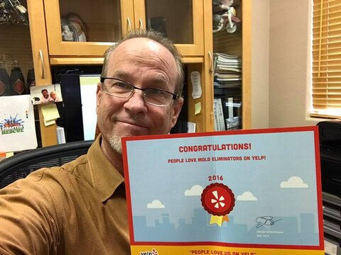 Craig Herrmann, President of Mold Eliminators Las Vegas, holding IICRC award